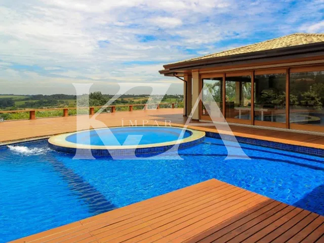 Imagem: A casa em condomínio possui 5 Dormitórios, 5 Suítes, 8
