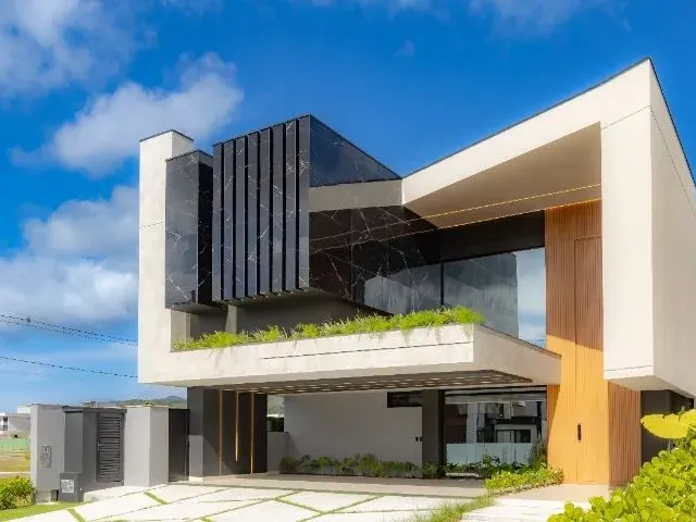 Imagem: A casa em condomínio possui 4 Dormitórios, 4 Suítes, 5